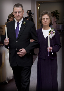 The Groom's Parents come up behind them to light the candle representing Daniel.
